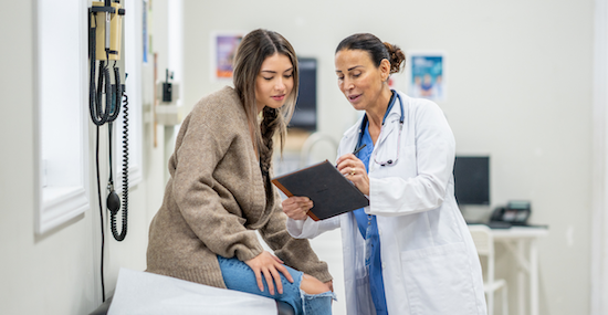 woman being seen at doctors appointment