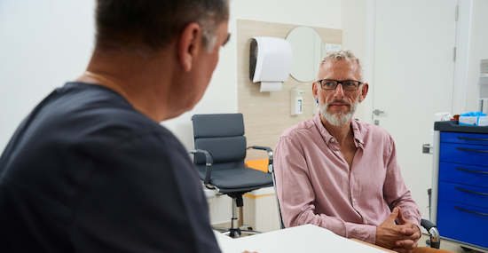 Man at doctors appointment speaking with his doctor