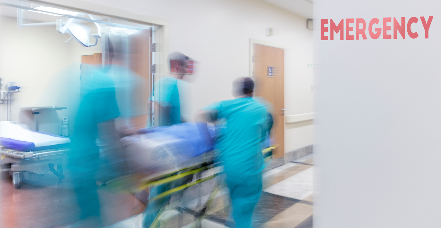 nurses wheeling patient in to the emergency room