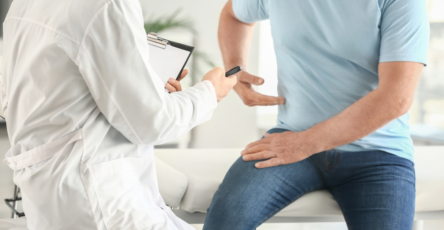 man at doctor appointment pointing to side