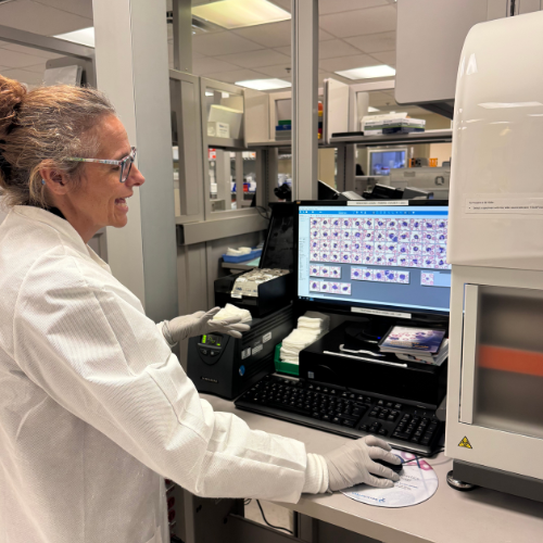 Judi in the medical lab at a computer