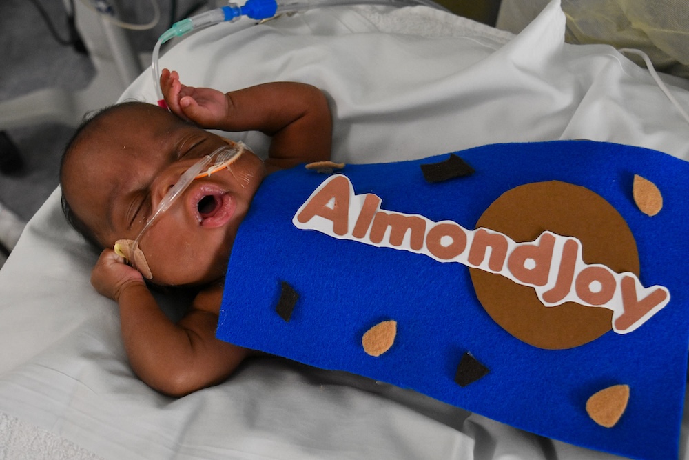 A baby in a Almond Joy costume